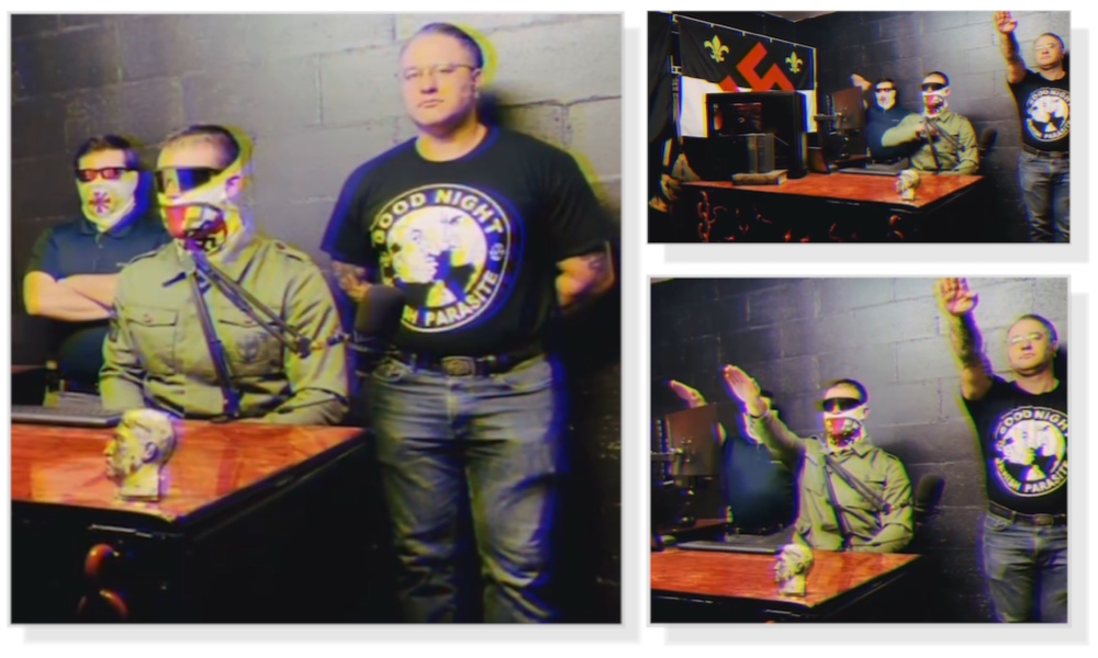 A series of three images taken from the same video. Three men are inside a room with dark grey walls. One man, standing on the left, is wearing jeans and a black shirt that says “Good Night Jewish Parasite”. Another man, standing on the right, is wearing a navy shirt, sunglasses and a white OMTO-branded gaiter mask. The third man is wearing an olive green dress shirt, sunglasses and a white OMTO gaiter. He is seated at a wood desk, between the two standing men and is reading off of a screen positioned in front of him. In the second and third images, all three men are giving “Seig Heil” salutes.