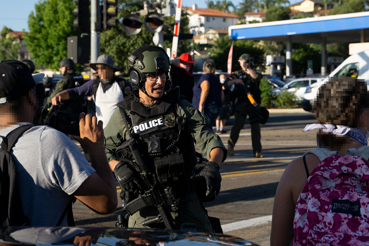 A SWAT officer with an M4 intervenes in the brawl. Photo by Tom Mann.