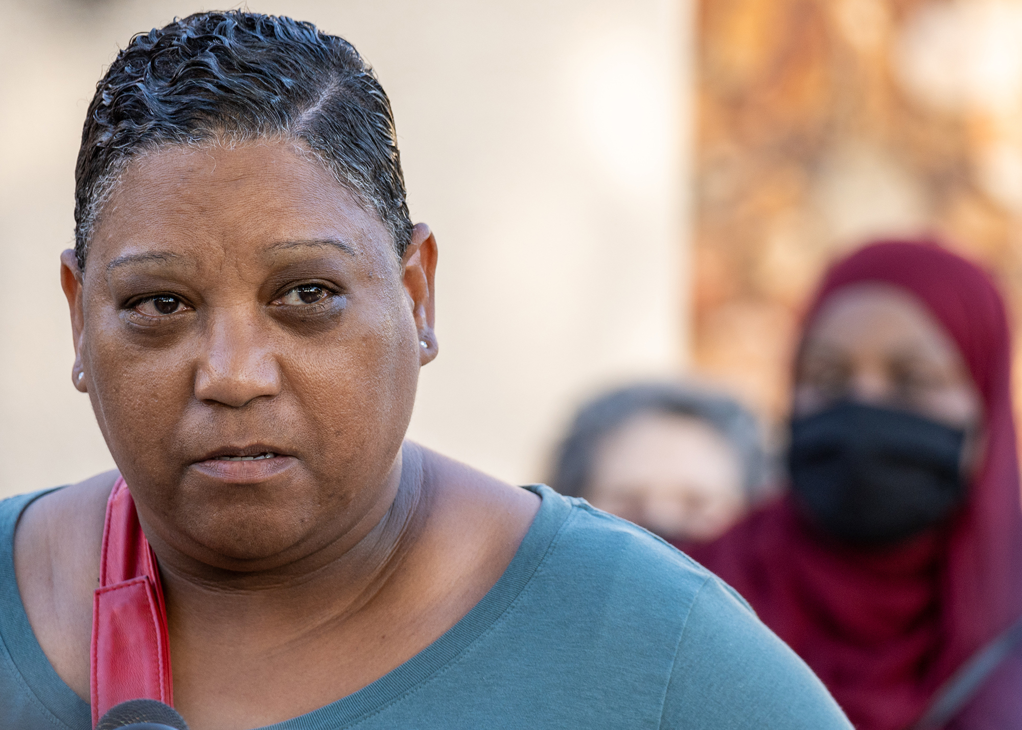 a close up shot of Tasha Williamson, with her face taking up nearly one third of the frame. Her facial expression is both pained and serious.