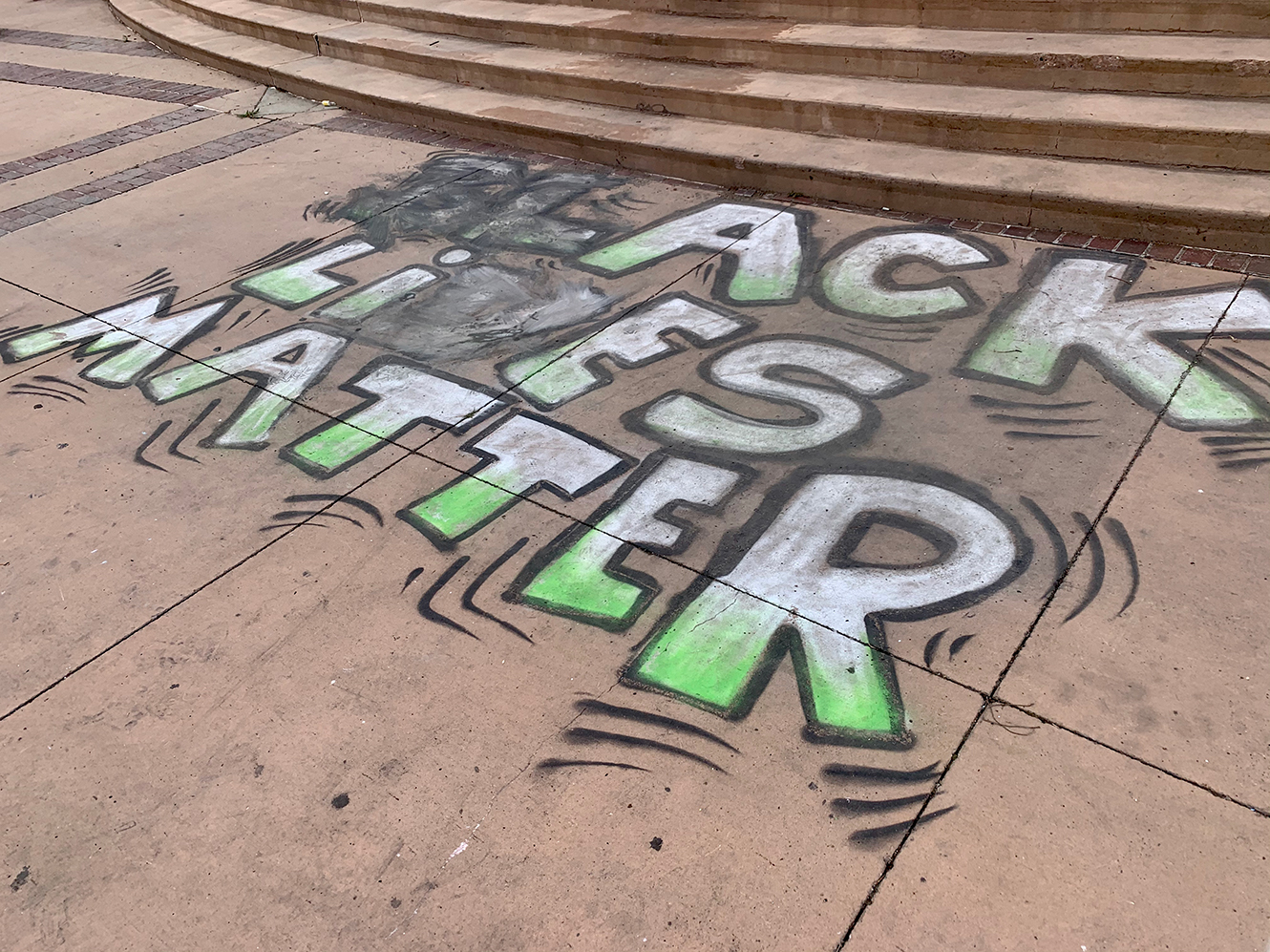 Black Lives Matter art after an anti-quarantine protester tried to remove it. Photo by Bella Davis.