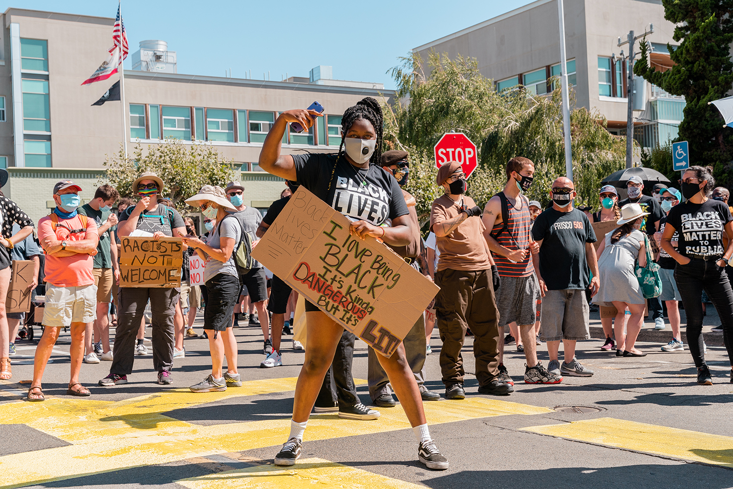 A protestor poses with a sign in front of the Contra Costa County Courthouse at the “Zero Tolerance for White Supremacy” protest in Martinez, Calif., on Sunday, July 12, 2020. “Black Lives Matter” was painted in large letters on the road in front of the courthouse with permission from the city — it was later vandalized by a couple who partially painted over it. They were eventually arrested, but won praise from Tucker Carlson for the act.