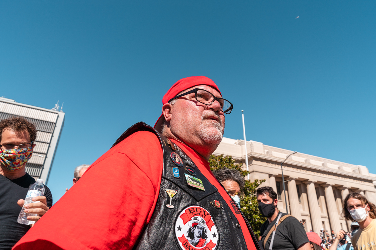 A counter-protester wearing a vest with patches from the group E Clampus Vitus makes their way through the crowd at the “Zero Tolerance for White Supremacy” protest in Martinez, Calif., on Sunday, July 12, 2020.