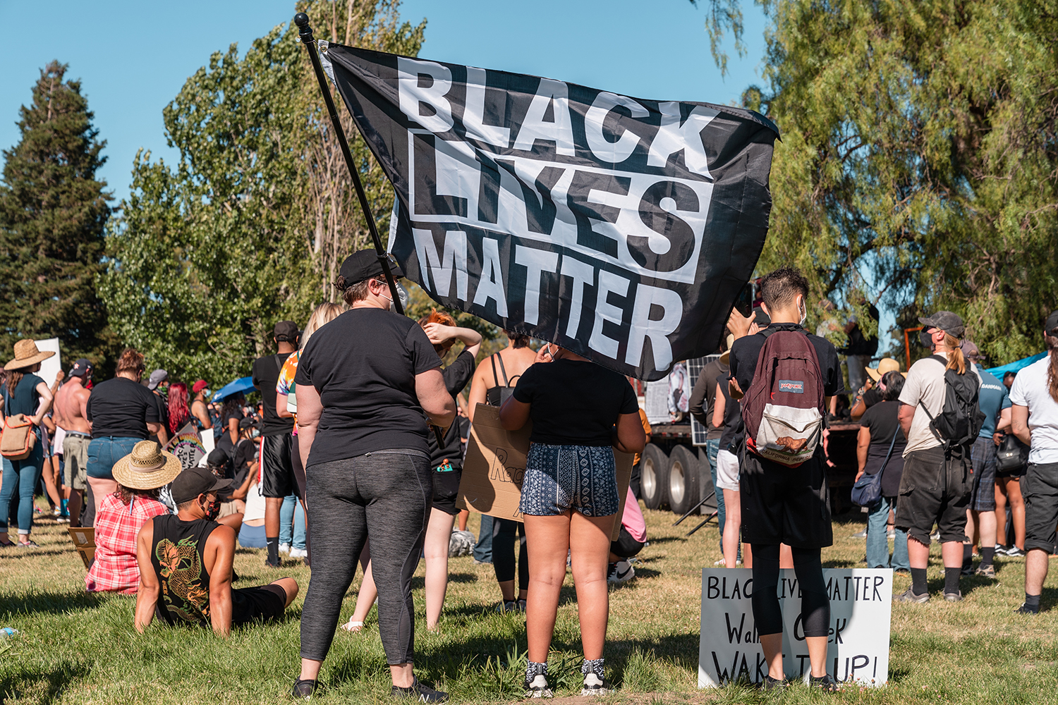 A Black Lives Matter flag is flown as people listen to speakers at the Waterfront Park during the “Zero Tolerance for White Supremacy” protest in Martinez, Calif., on Sunday, July 12, 2020.