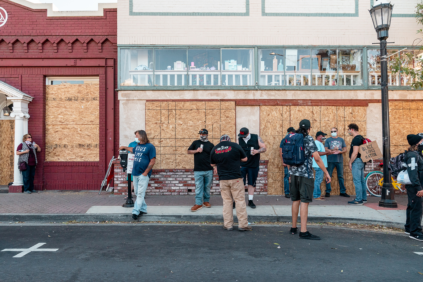 A group including some counter protesters have conversations while drinking in public during the “Zero Tolerance for White Supremacy” protest in Martinez, Calif., on Sunday, July 12, 2020.