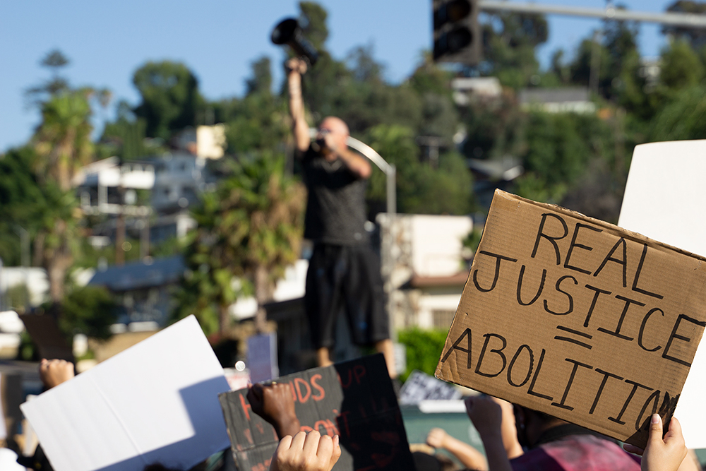 The protest was lead by a van to protect it from vehicular attacks. The van also doubled as a stage. Photo by Tom Mann.