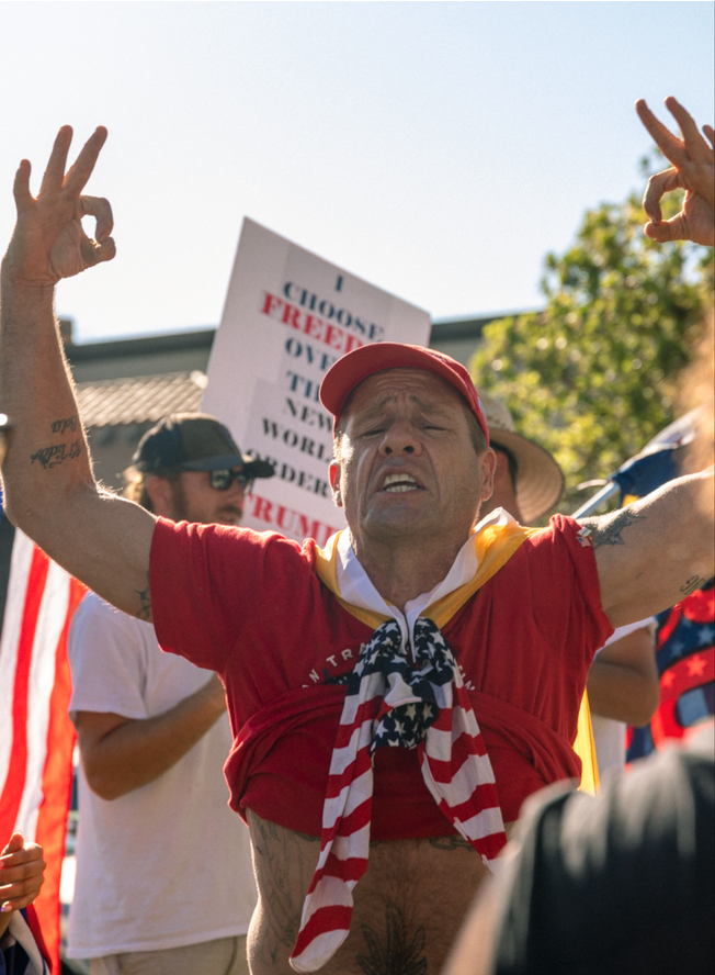 Far-right supporter John Turano, 'Based Spartan' displaying white power hand symbols.