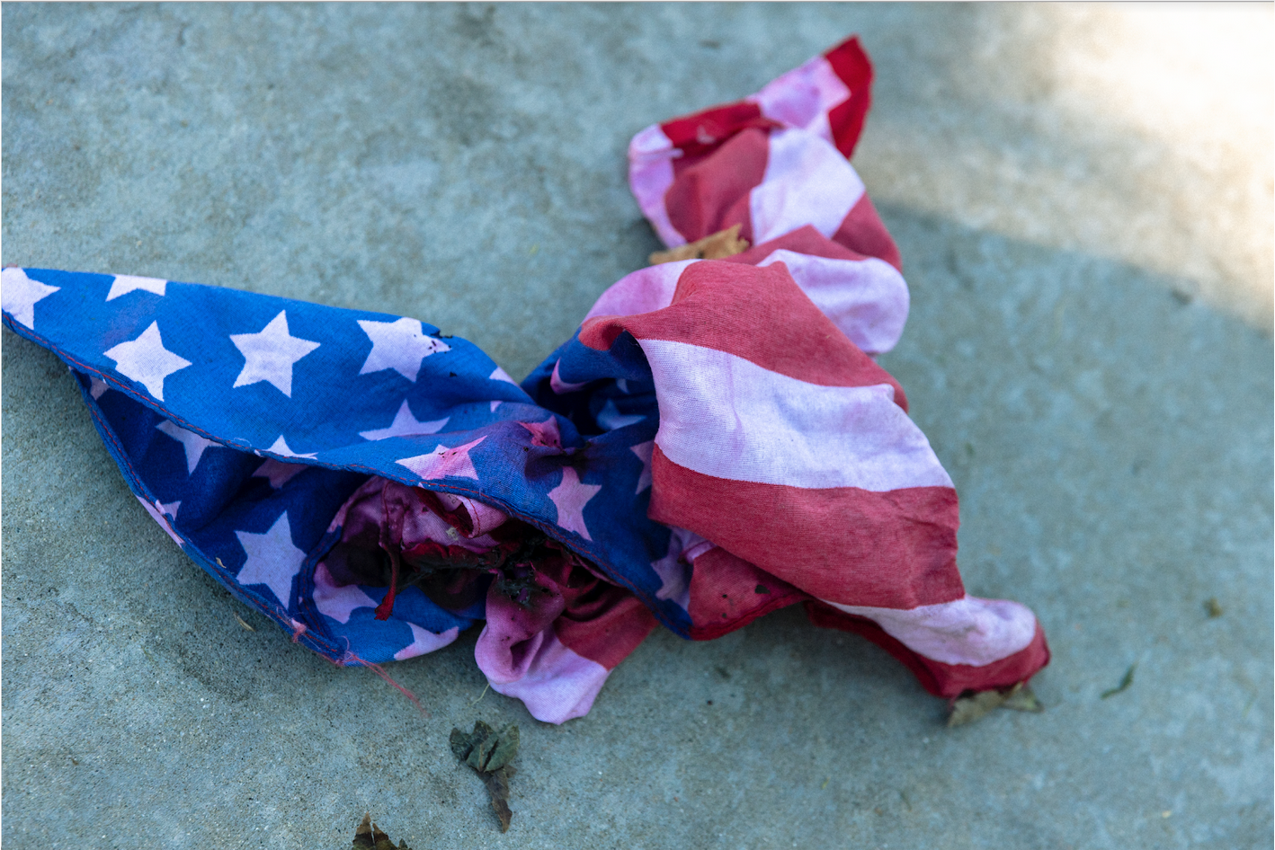 Tattered; smoke-stained American flag.