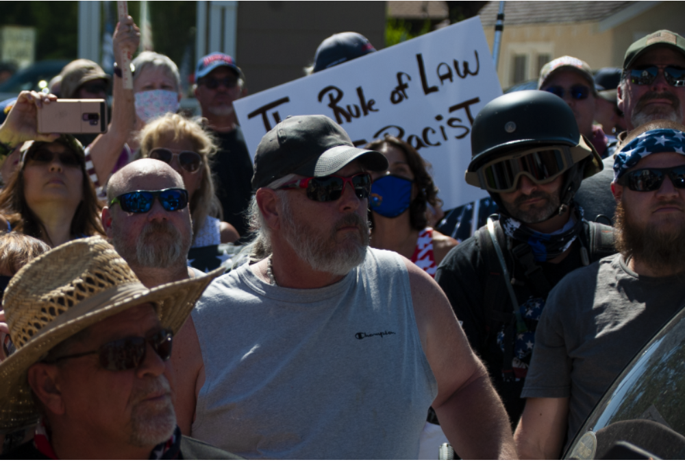 Members of local militias and Douglas County locals chase BLM activists out of their assigned 'Free Speech Zone'. Photo by JJ Mazzucotelli.