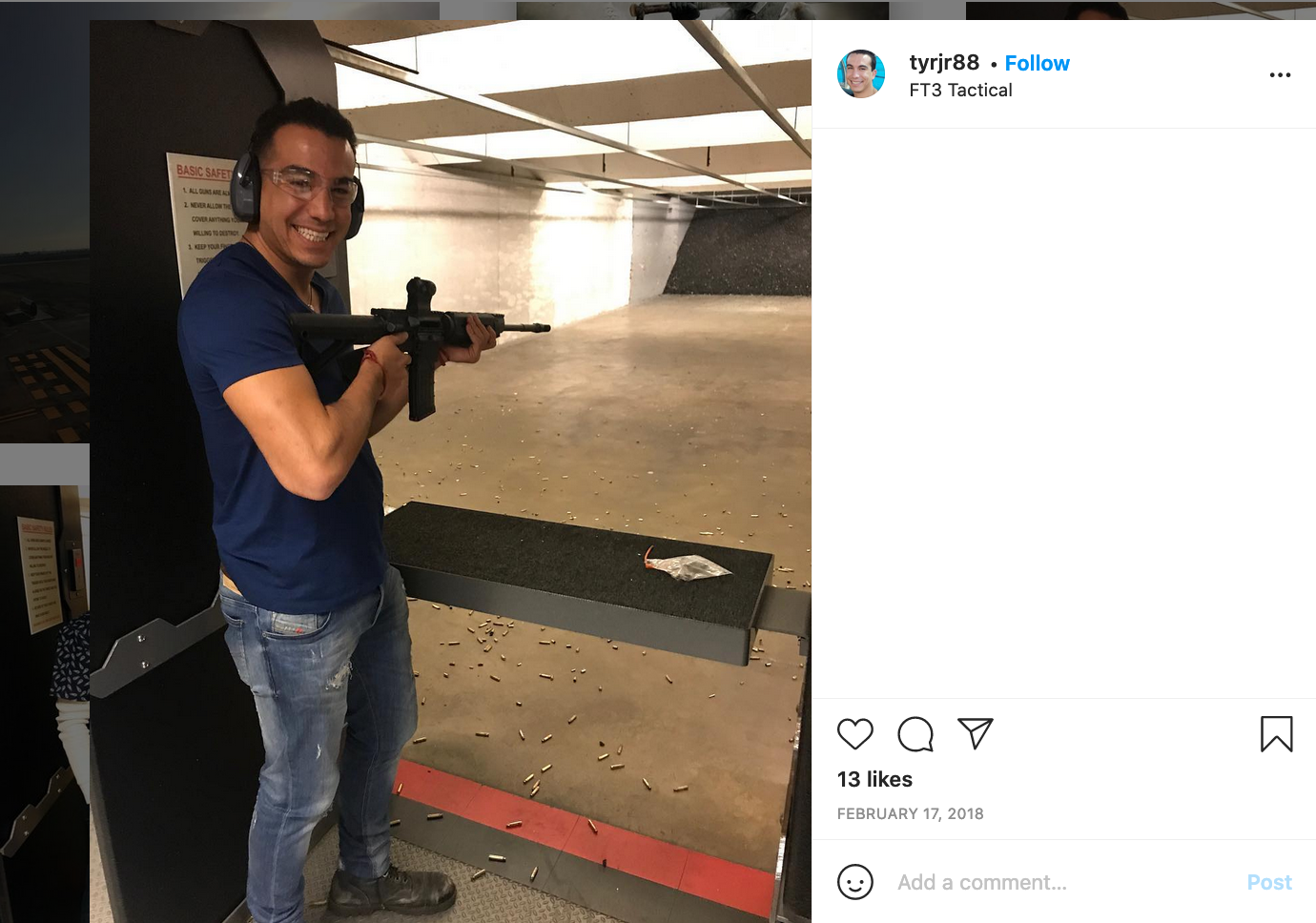 Roman smiling and posing with a rifle at a shooting range.