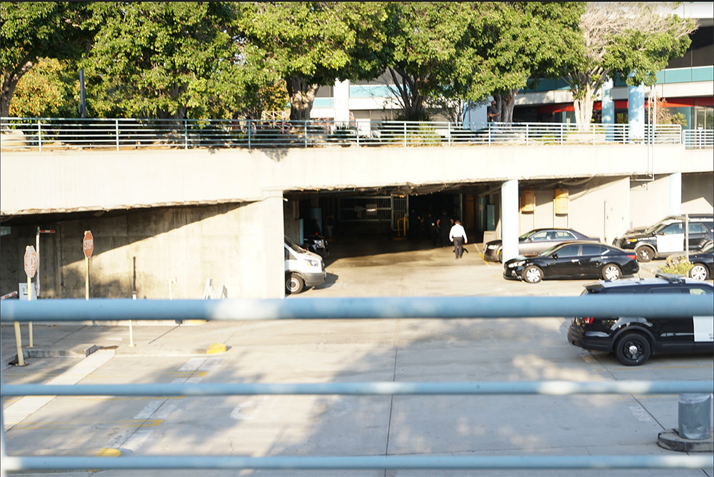 Parker is carried by police into the station after seizing. Photo by Tom Mann.