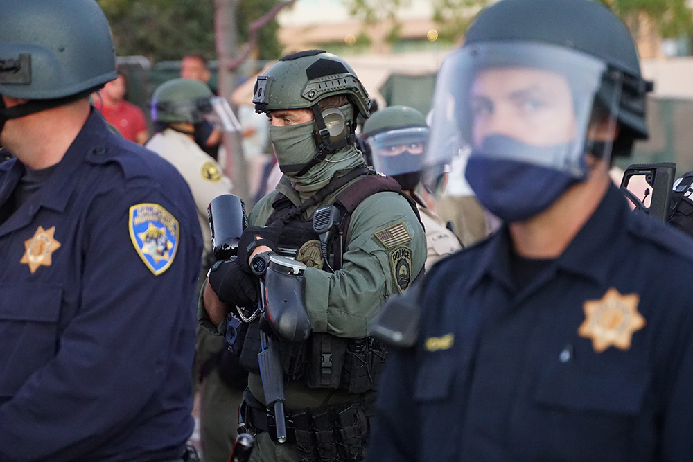 Most officers eschewed masks, but this SWAT team member didn't. Photo by Tom Mann.