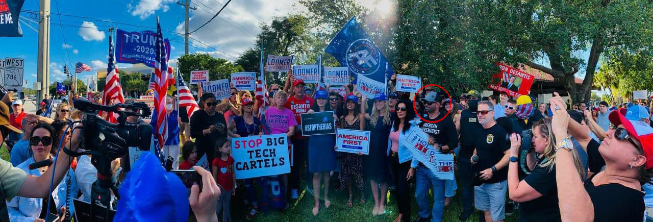 Tarrio standing next to Loomer in a panorama shot with a mostly white crowd gathered around them holding campaign signs for Loomer.